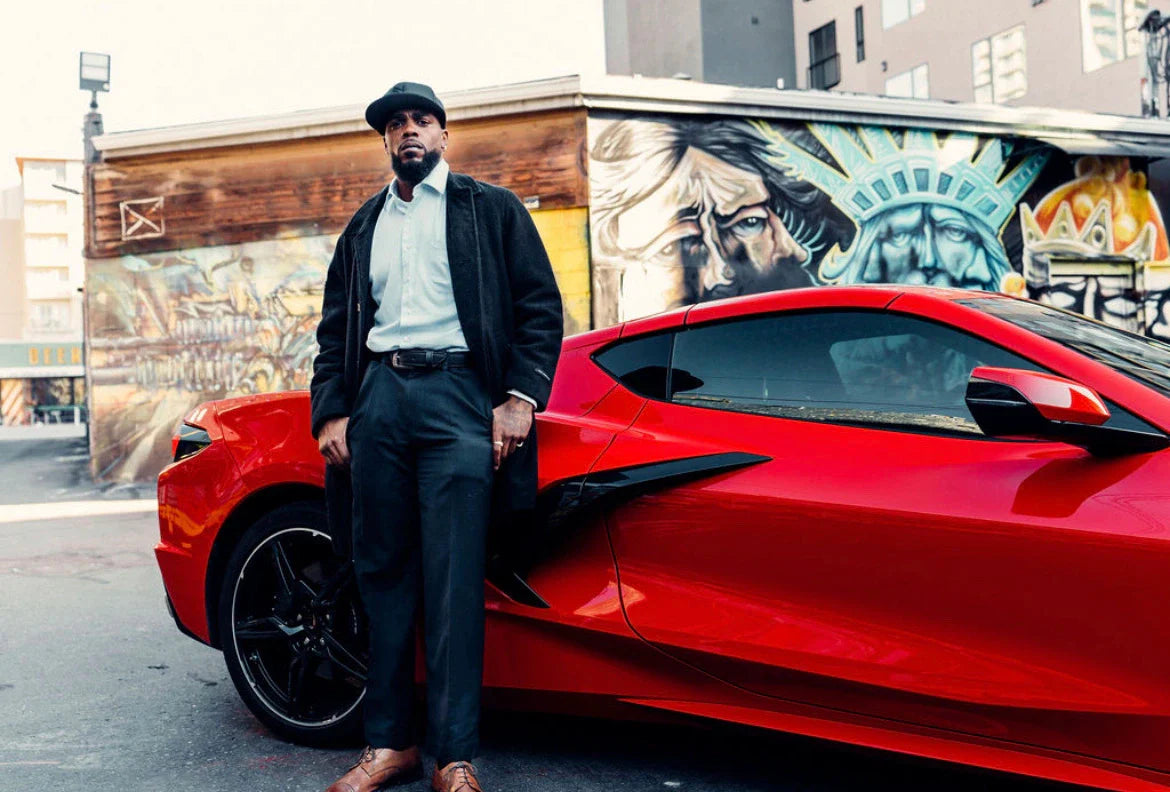 photo of Tanqueray Towns standing in front of a red sports car