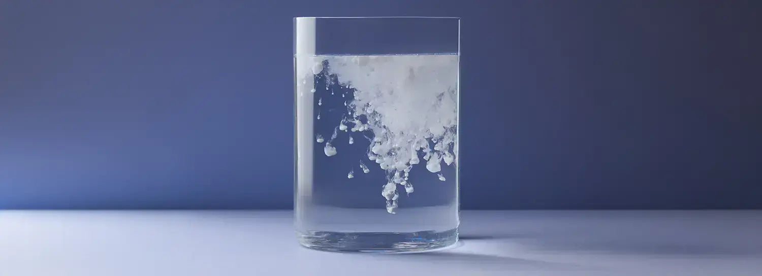 Instantized creatine dissolving fully in a glass of water, no sediment