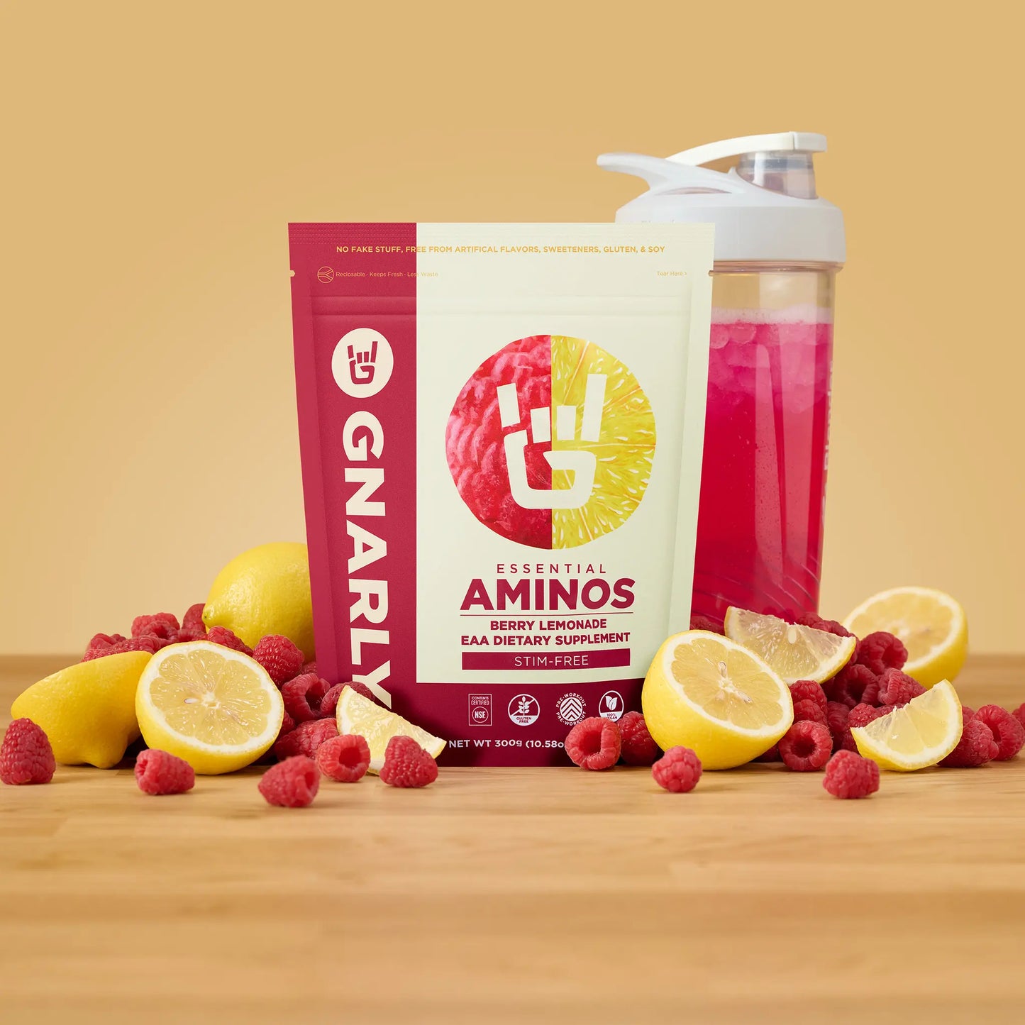 Gnarly Aminos supplement packaging with berries and lemons on a wooden surface