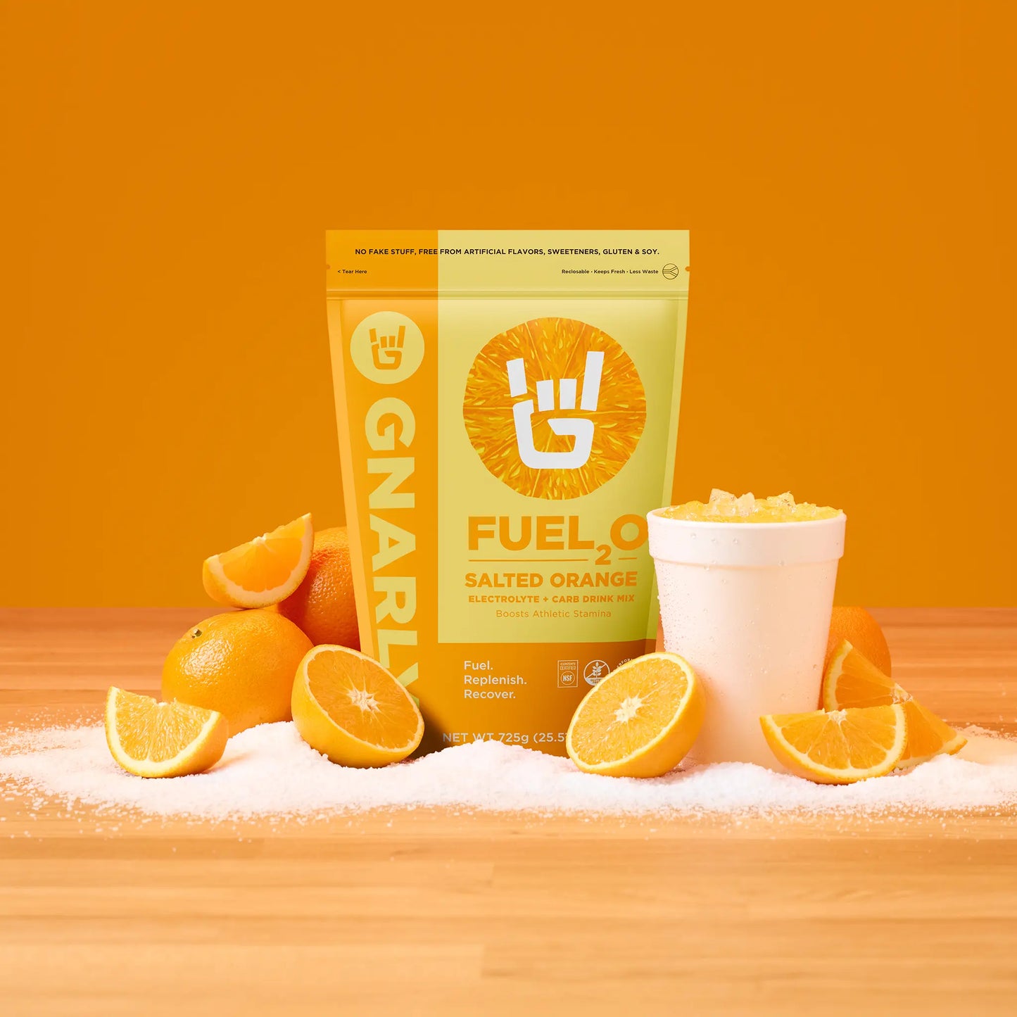 Gnarly Fuel 2 Salted Orange supplement package with oranges on a wooden surface and orange background