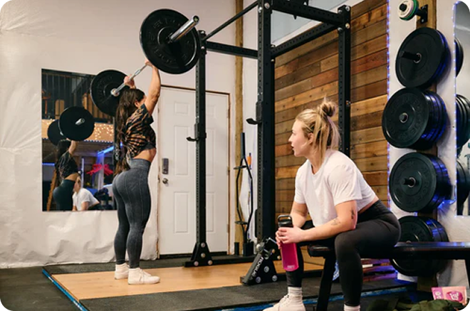 Two women in a gym working out